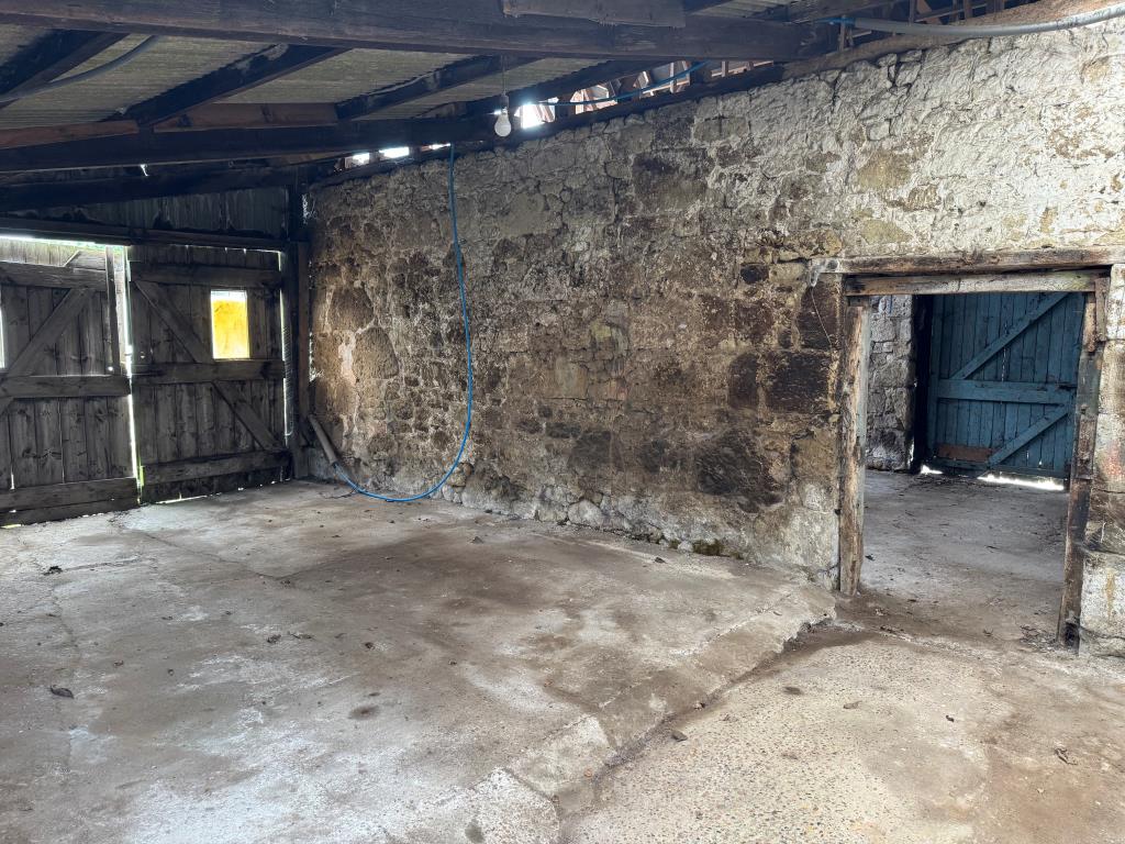 Lot: 53 - TRADITIONAL FARMHOUSE FOR IMPROVEMENT WITH BARNS AND OUTBUILDINGS ON A 2.5 ACRE PLOT - A Look Inside one of the Barns at the Side